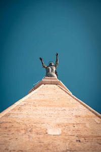Low angle view of statue against clear blue sky