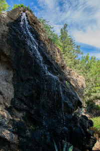 Low angle view of rock formation against sky