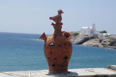 Close-up of coin-operated binoculars against sea