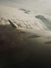 Aerial view of aircraft wing against sky