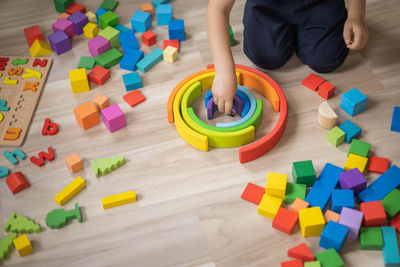 High angle view of boy playing with toys on table