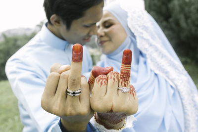 Midsection of couple holding hands