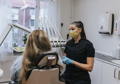 Female dentist with patient in dentist's office