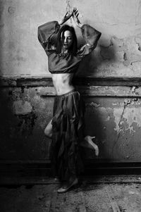 Statue of woman against wall