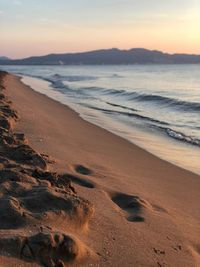 Scenic view of beach against sky during sunset