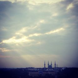 View of buildings against cloudy sky