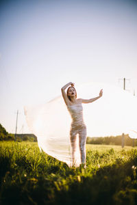 Full length of woman on field against sky