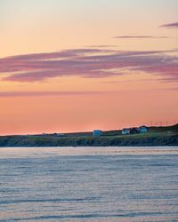 Scenic view of sea against orange sky