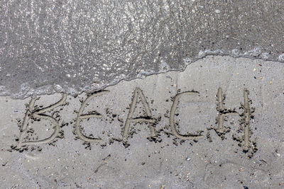 High angle view of heart shape on sand