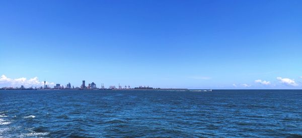 Scenic view of sea against clear blue sky