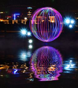 Illuminated ferris wheel at night