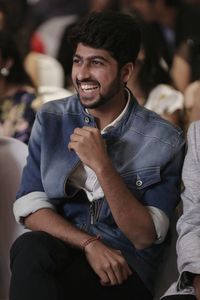 Smiling man looking away while sitting on chair