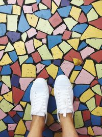 Low section of woman standing on tiled floor