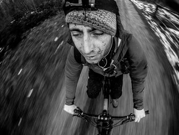 Man looking away while riding bicycle