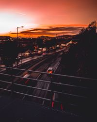 Road in city against sky during sunset