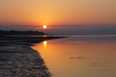 Scenic view of sea against romantic sky at sunset