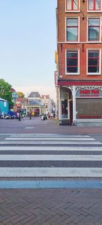 View of city street and buildings against sky