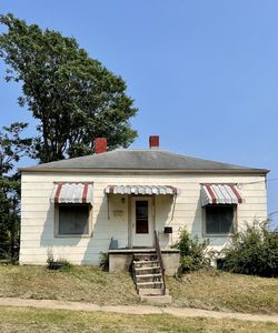 House and trees against blue sky