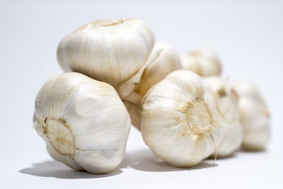 Close-up of garlic over white background