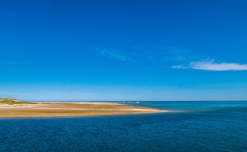 Scenic view of sea against blue sky