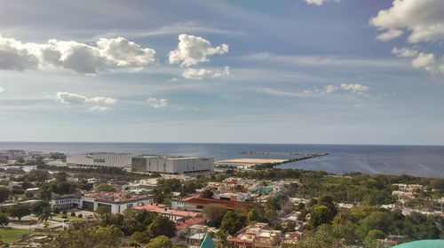 Scenic view of sea and town against sky