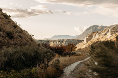 Scenic view of mountains and hoodoos against sky