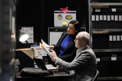 Side view of man using mobile phone in office