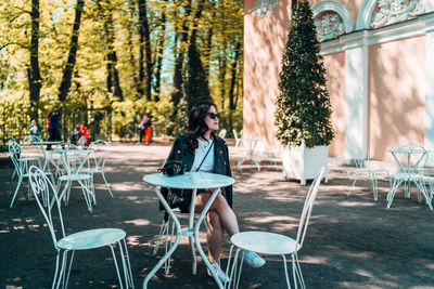 Woman sitting on chair at table