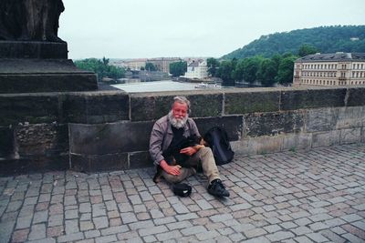 Full length of woman sitting on bench