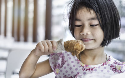 Portrait of cute girl holding ice cream
