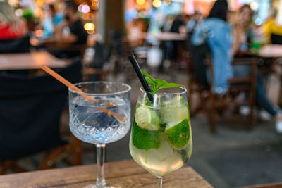 Close-up of refreshing cocktail and gin tonic on table in bar in city