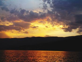 Scenic view of silhouette mountains against sky during sunset