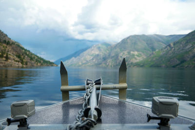 Scenic view of boat anchor against lake and mountains