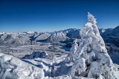 Scenic view of snowcapped mountains against clear blue sky