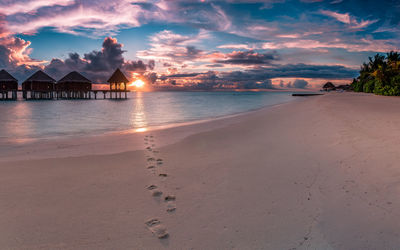 Scenic view of beach against sky during sunset