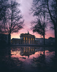 Reflection of building in lake at sunset