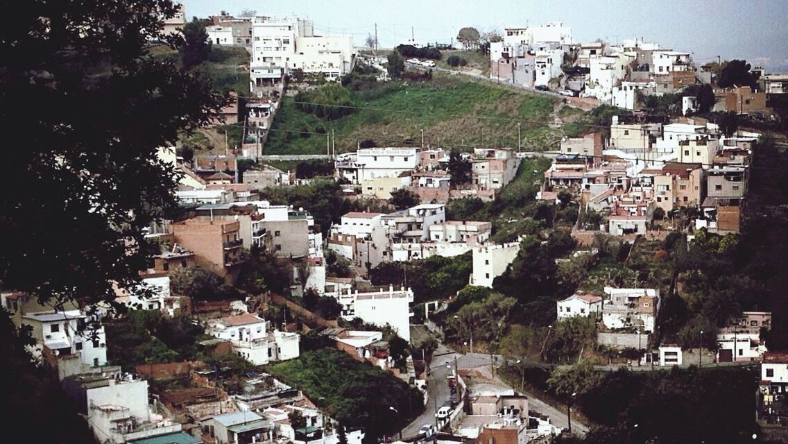 building exterior, architecture, built structure, city, high angle view, residential district, cityscape, residential building, residential structure, crowded, house, tree, car, city life, road, town, street, townscape, outdoors, day