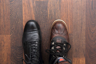 Low section of a man standing on wooden floor