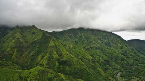 Scenic view of green mountains against sky