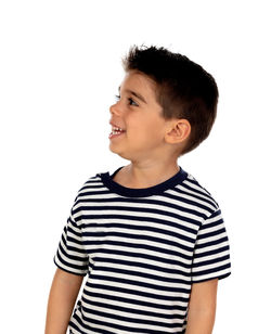 Happy boy looking away against white background