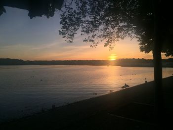 Scenic view of lake against sky during sunset