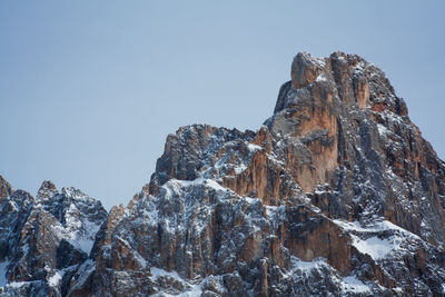 Low angle view of snow capped mountain against sky