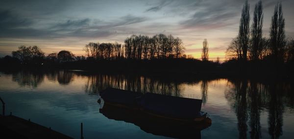 Scenic view of lake against sky during sunset