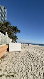 Scenic view of beach against clear blue sky