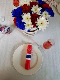 High angle view of red roses in vase on table