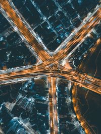 High angle view of illuminated city street and buildings at night