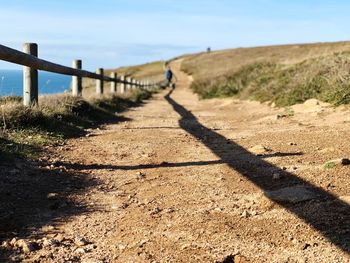 Shadow of railing on footpath