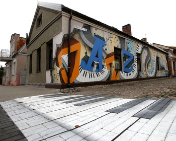 Graffiti on wall of building against sky