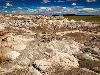 Scenic view of desert landscape against sky at petrified forest national park, united states.