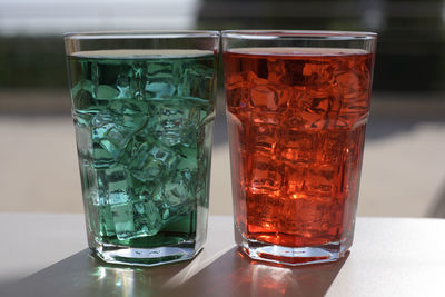 Colored drinks with ice cubes